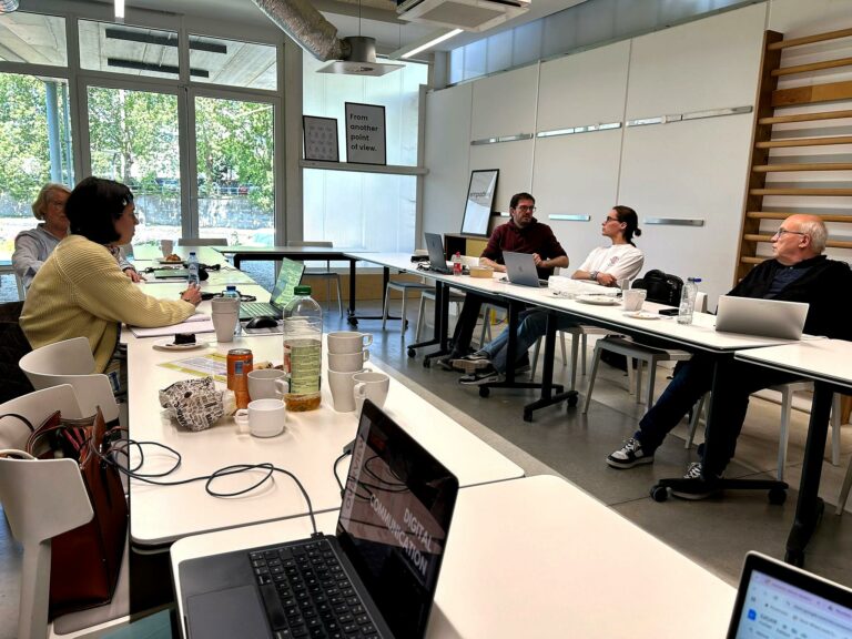 Plenary meeting of S2G XR project partners at SkalUP offices in Namur, discussing strategy and reviewing digital presentations on laptops