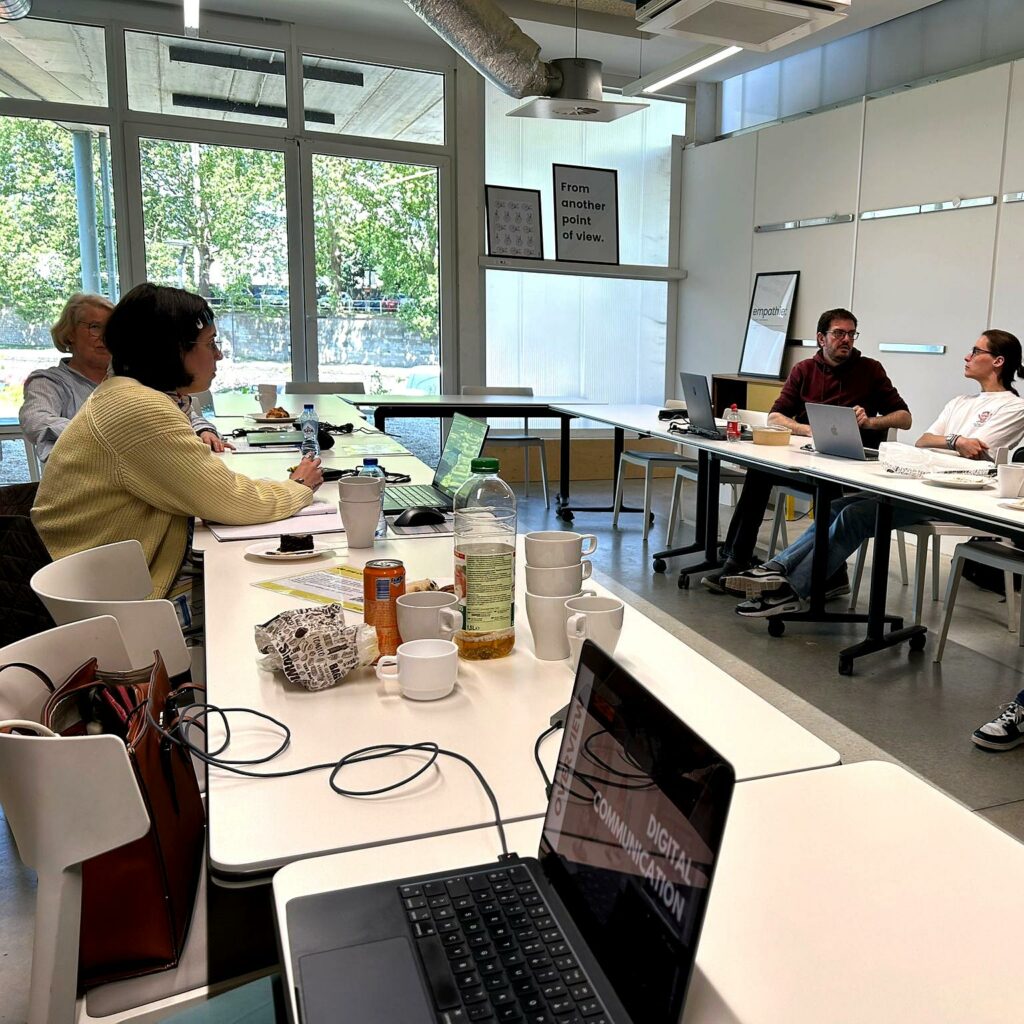 Plenary meeting of S2G XR project partners at SkalUP offices in Namur, discussing strategy and reviewing digital presentations on laptops